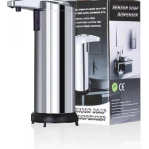 Dispensador automático de jabón en acero inoxidable con sensor infrarrojo, base negra y empaque visible al fondo.