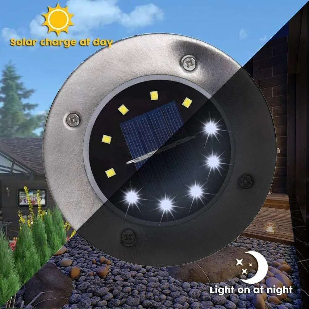 Luz de piso solar circular con panel fotovoltaico central, LEDs amarillos y blanco, carcasa metálica y base negra, para exteriores.