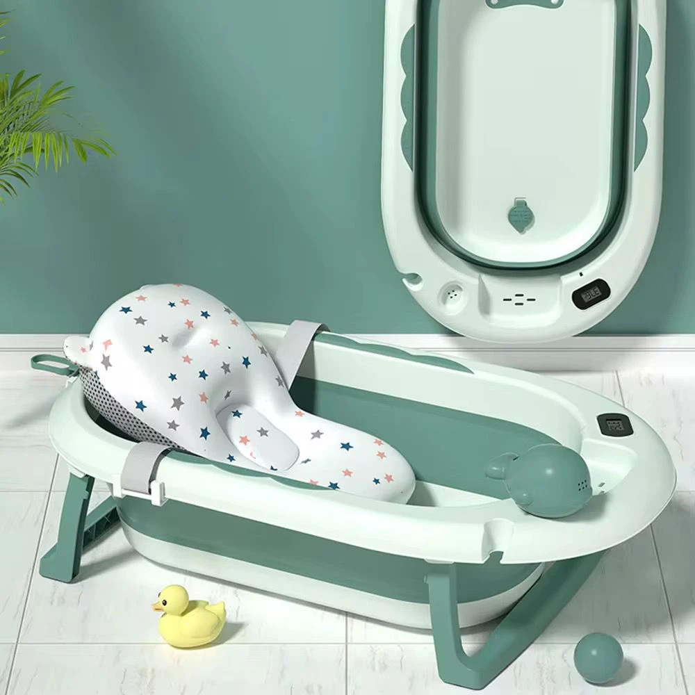 Bañera plegable para bebé con soporte en forma de ballena, color verde menta y blanco, con base metálica y accesorios incluidos.