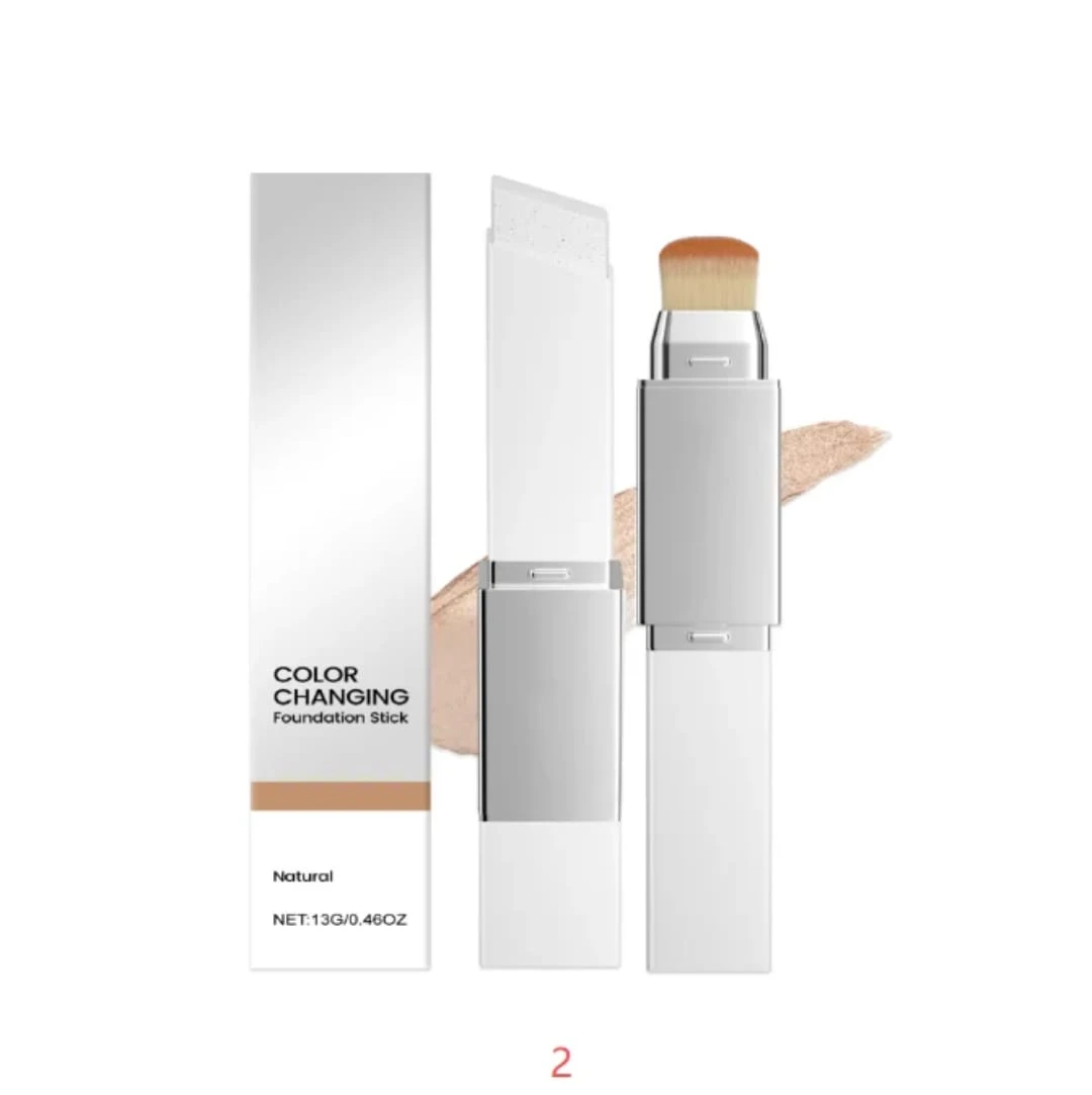 Base hidratante vegana con cambio de color, presentación en stick con aplicador de cerdas y muestra de tono natural. Incluye caja y envoltorio blanco.