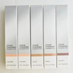 Cinco bases hidratantes veganas con cambio de color en presentación de stick, tonos desde Ivory White hasta Dark Skin, con etiquetas que indican 13g o 0.46oz.