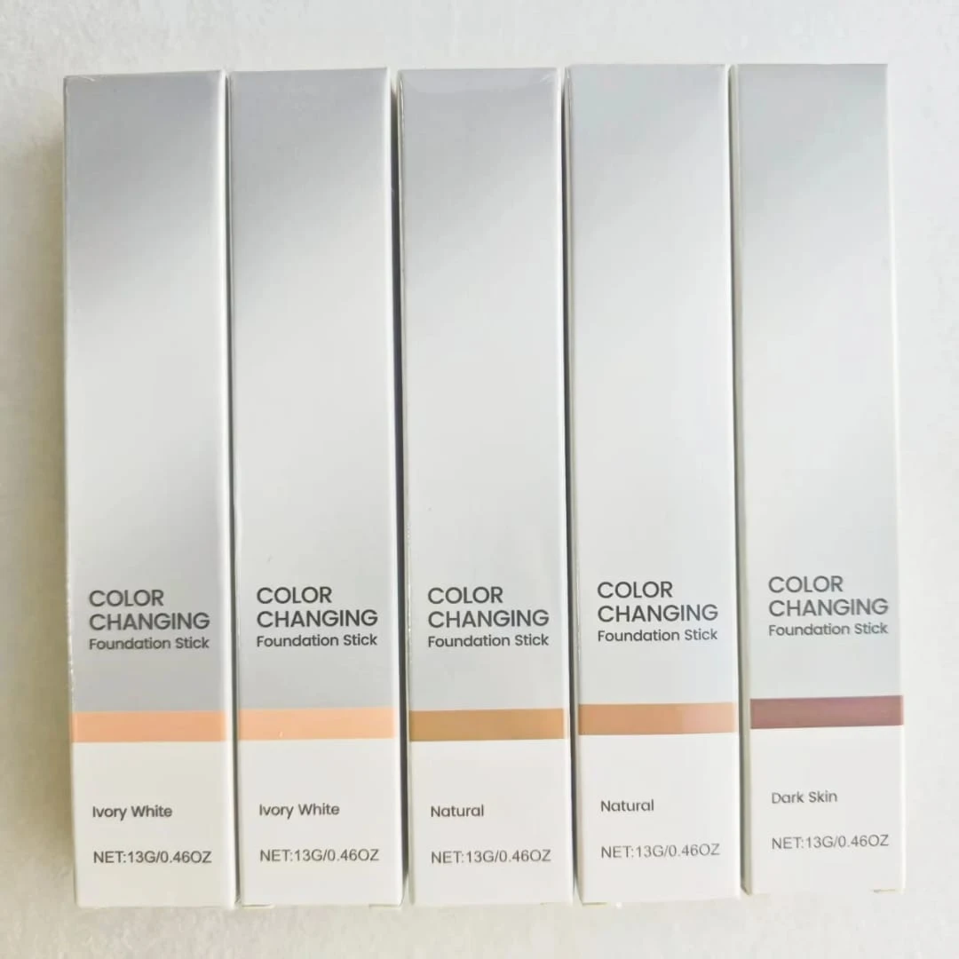 Cinco bases hidratantes veganas con cambio de color en presentación de stick, tonos desde Ivory White hasta Dark Skin, con etiquetas que indican 13g o 0.46oz.