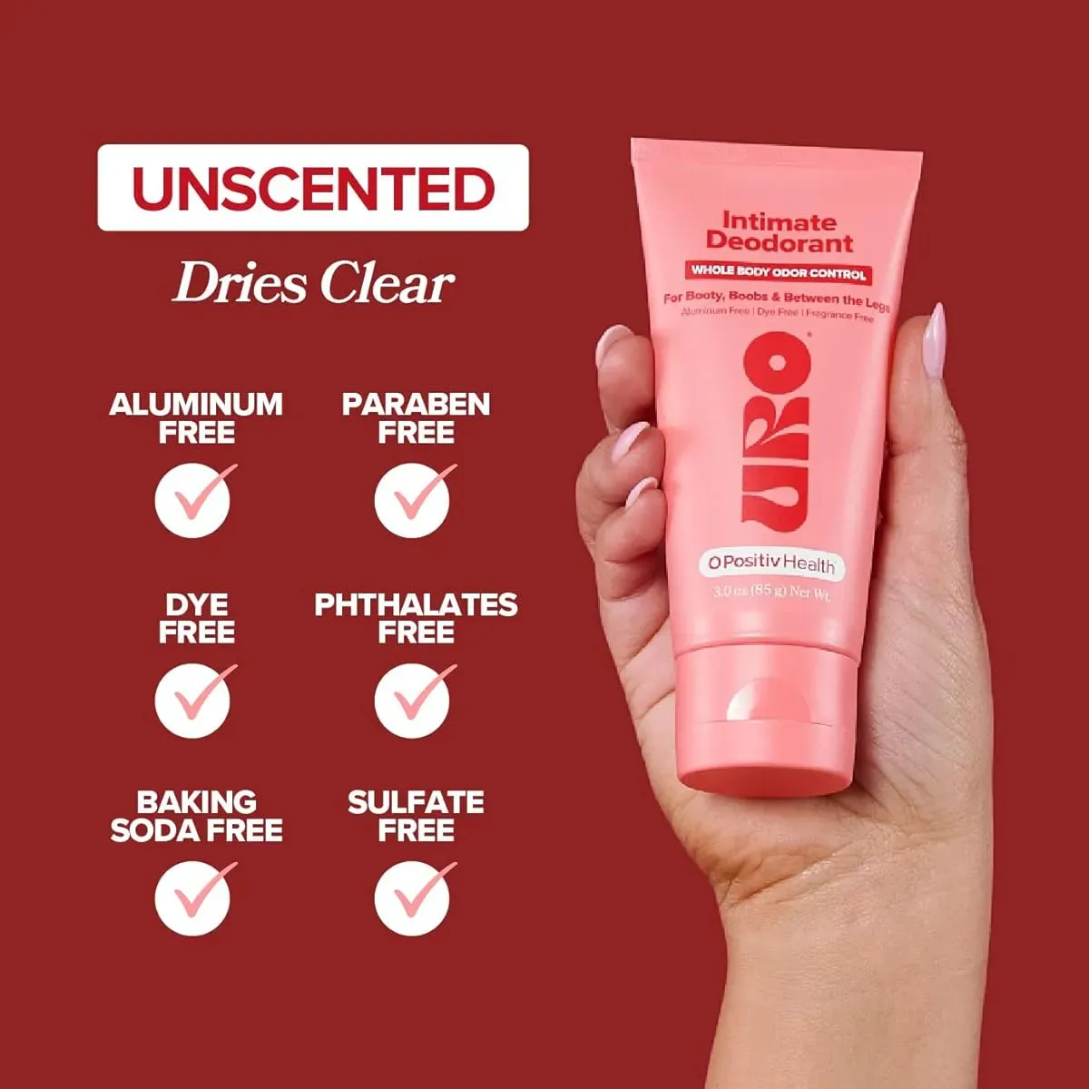 Tubo rosa de desodorante íntimo sin aluminio, parabenos ni sulfatos, con etiqueta que indica “Dries Clear” y lista de ingredientes libres.