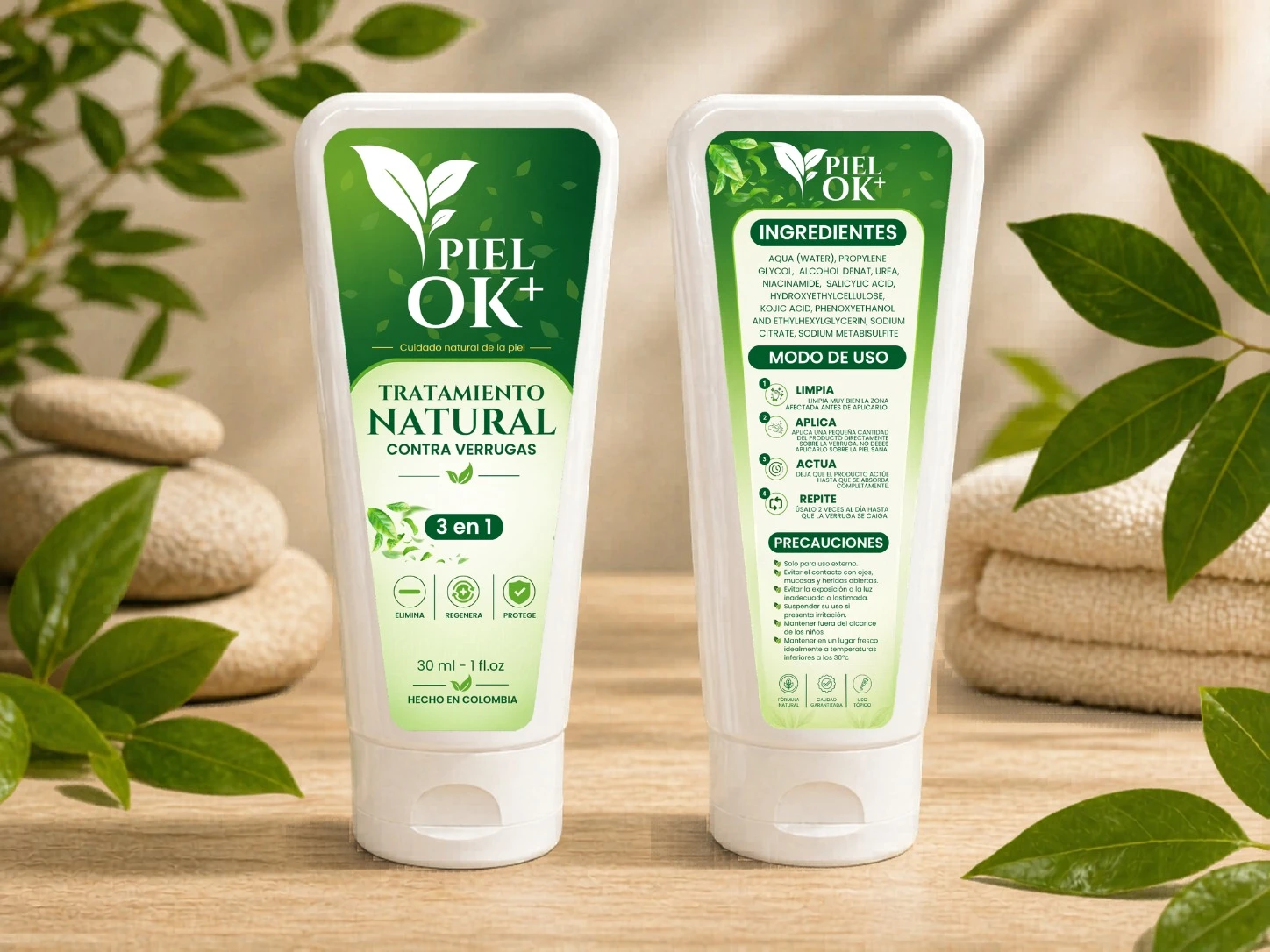Tubo blanco de Piel Ok 30 ml con etiqueta verde, mostrando frente y espalda del envase. Incluye tratamiento natural contra verrugas, 3 en 1, con instrucciones y advertencias visibles. Sobre madera, rodeado de hojas verdes y piedras lisas.