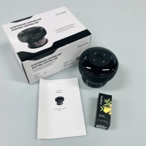 Pack de ventosa eléctrica Houbie negra con caja, manual y aceite de jengibre, sobre fondo blanco.