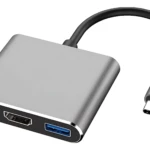 Adaptador USB-C de aluminio con cable flexible, incluye puertos HDMI, USB 3.0 y carga simultánea para laptop.