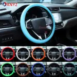 Cubierta de volante de silicona en azul claro, vista frontal en interior de auto. Incluye set de dos unidades en colores variados: rojo, blanco, naranja, gris, morado, verde, marrón, azul oscuro y negro.