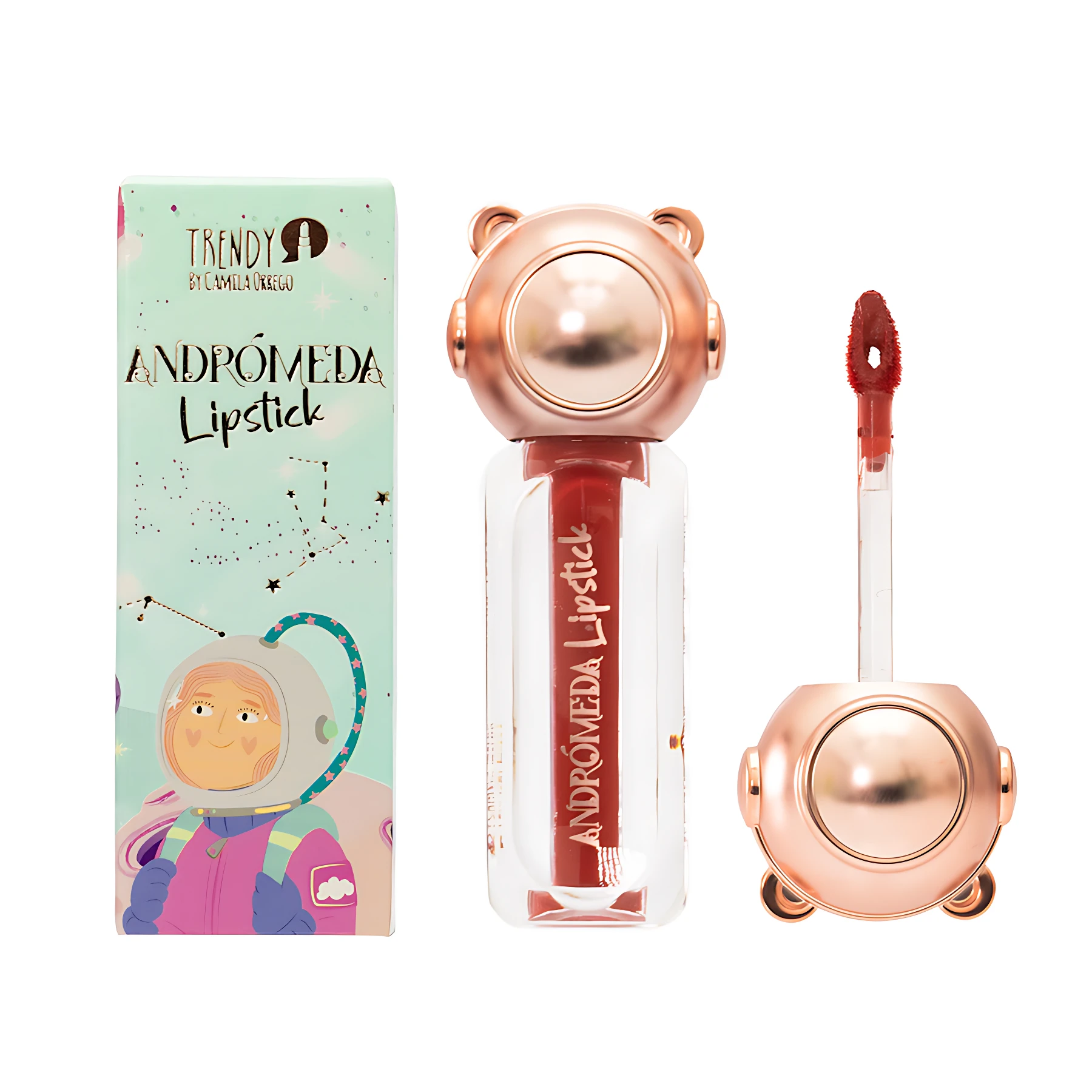 Labial líquido Andromeda en tono rojizo con acabado aterciopelado, envase transparente con tapa metálica rosada en forma de cabeza de oso, aplicador visible y caja ilustrada con astronauta.