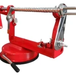 Máquina manual roja para pelar y cortar frutas y verduras, con base magnética y mango ergonómico.