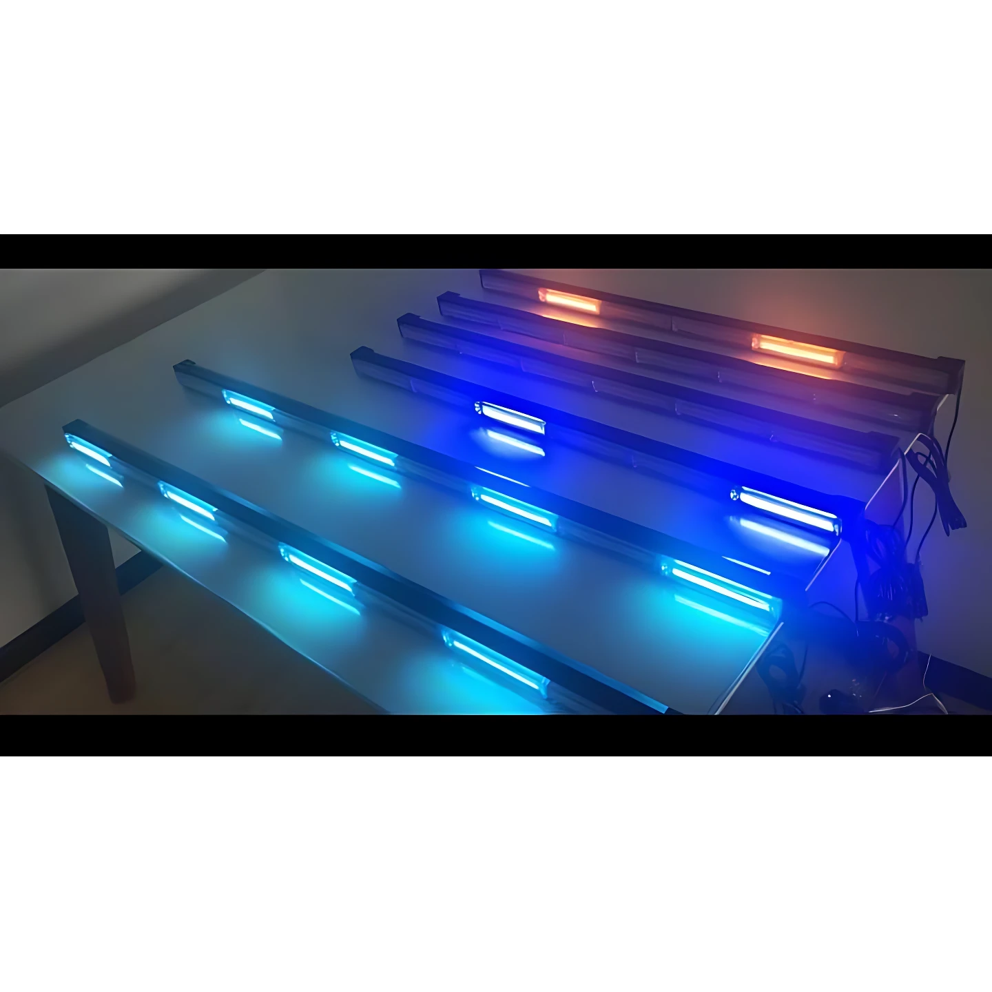 Cinco barras LED Raptor de 18 pulgadas en tonos azul y rojo, montadas sobre una superficie metálica, mostrando su diseño secuencial y estroboscópico para uso vehicular.