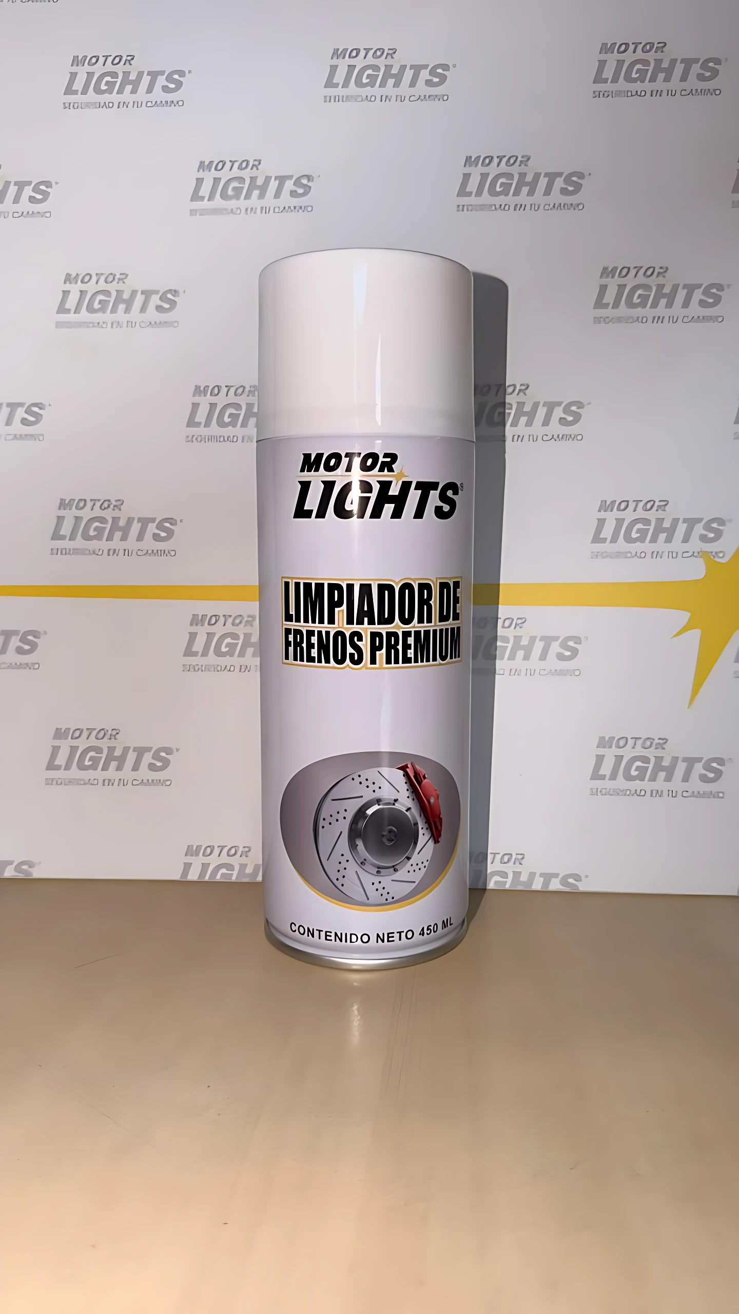 Botella de limpiador de frenos Motor Lights, color blanco con etiqueta negra y gris, muestra disco de freno en frontal.