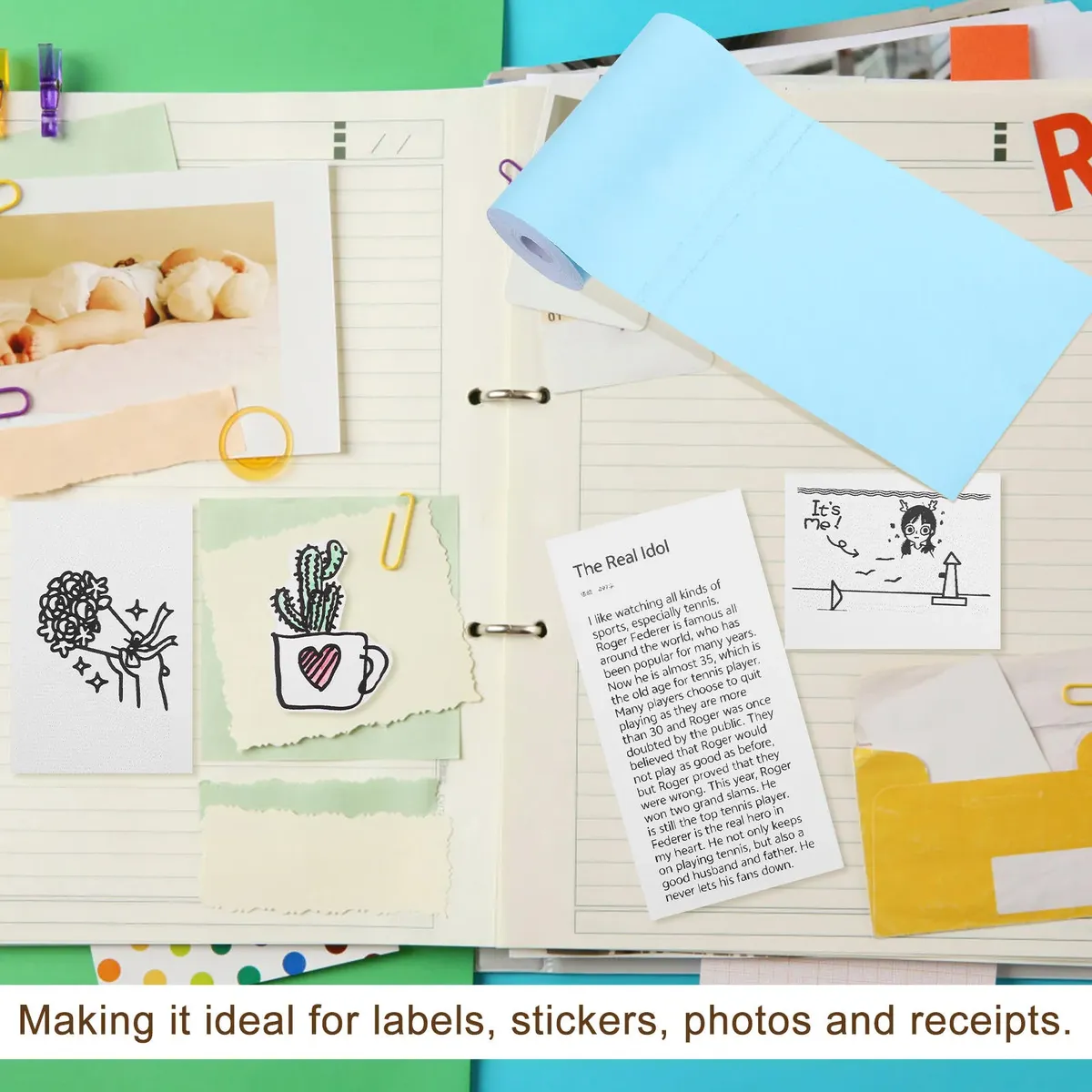 Rollo de papel térmico adhesivo color celeste para impresora portátil sobre cuaderno decorado con notas y recortes.