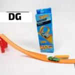 Pista Hot Wheels naranja de acrobacias con rampa roja, carro verde en la vía y caja azul del set Workshop Track.