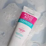 Tubo de limpiador facial de ácido kójico y colágeno sobre espuma, presentación de 100 gramos con diseño blanco y fucsia.