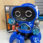 Robot juguete interactivo azul de seis patas con luces LED en las manos y la pantalla frontal, acompañado de su caja de empaque en una superficie blanca.