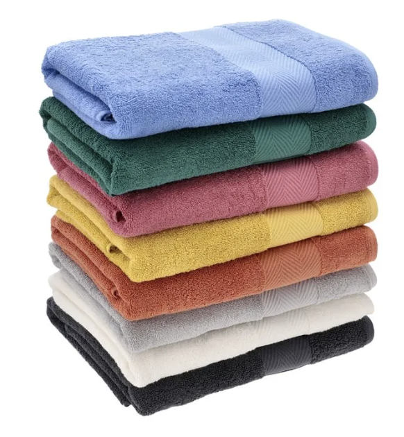 Pila de toallones de algodón premium en colores azul, verde, rosa, amarillo, naranja, gris, crema y negro, con textura suave de rizo.