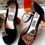 Zapatos negros de gamuza con bordado multicolor en la punta, correa con hebilla dorada y tacón bajo. Marca Siomh, modelo P214NDC.