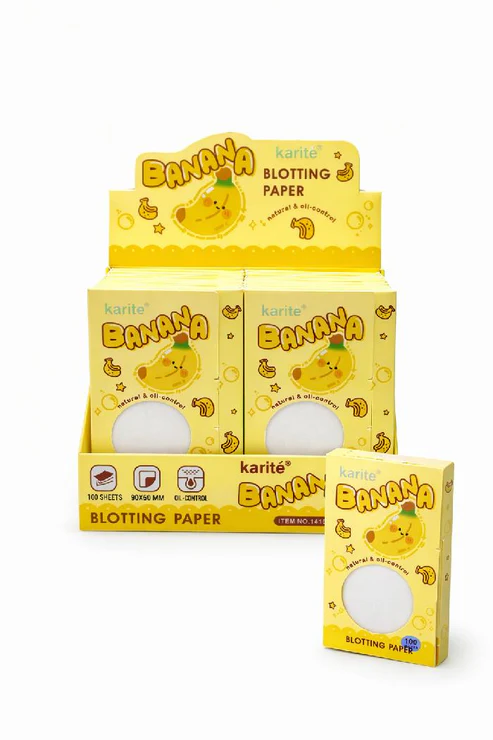 Set de tres papeles absorbentes de grasa facial con extracto de banana y control de brillo en exhibidor amarillo de cartón.
