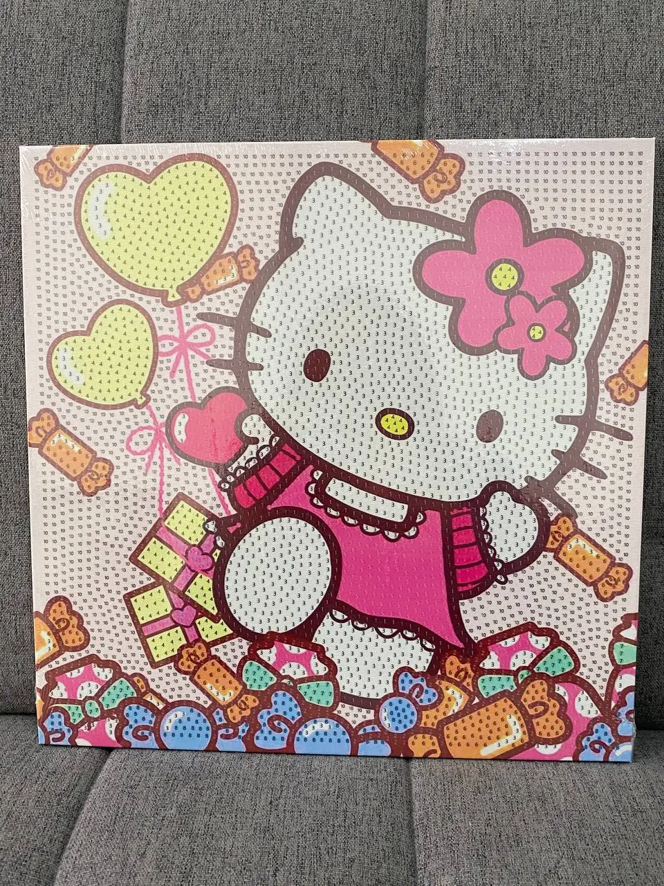 Kit de pintura diamante 3D con diseño de Hello Kitty estilo pop art en tonos rosa y amarillo, con globos de corazón y dulces.