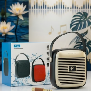 Parlante portátil Bluetooth con frontal dorado y cuerpo negro, junto a su caja con variantes negro y rojo y un cable auxiliar.
