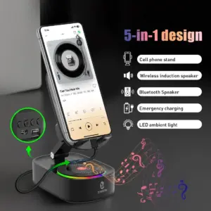 Soporte negro plegable para celular sobre base ovalada con parlante circular, luces LED de colores y panel de control lateral con puertos USB.