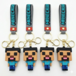 Cuatro llaveros de silicona 3D de Minecraft con figuras de personajes, correas grises con texto azul y ganchos metálicos dorados.