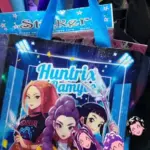 Bolsa ecológica azul con diseño de K-pop y tres personajes de anime, ideal para recolectar dulces.