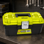Caja de herramientas plástica DYLLU amarillo neón y gris con cierre metálico y compartimentos en la tapa, sobre un banco de trabajo.