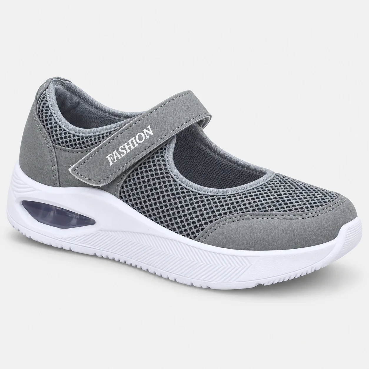 Zapatilla ortopédica gris de malla transpirable con cierre de velcro y suela blanca con cámara de aire para amortiguación.