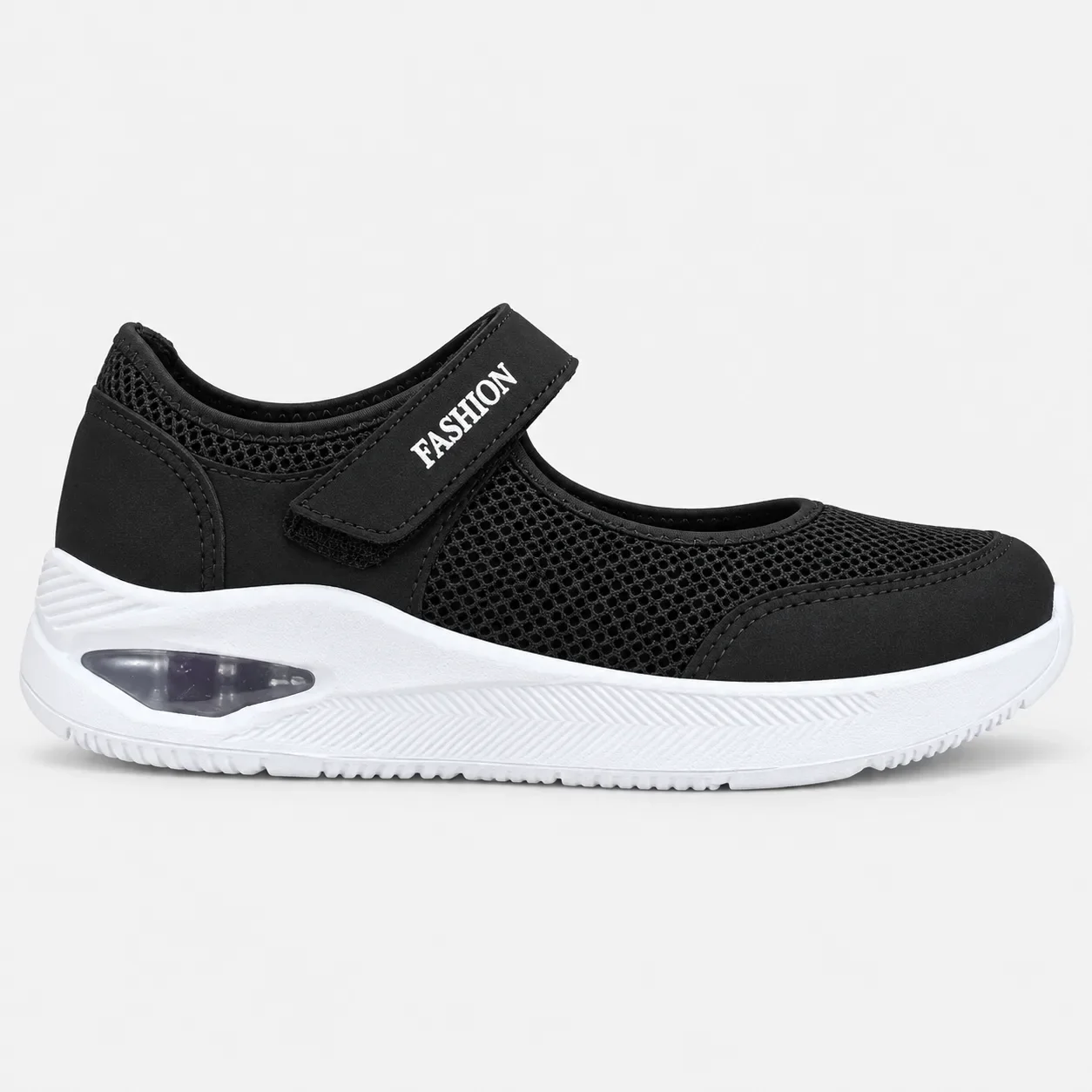 Zapato ortopédico tipo Mary Jane para mujer en malla negra, con correa ajustable con texto FASHION y suela blanca gruesa con cámara de aire visible.