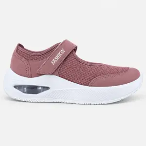 Zapatilla ortopédica de mujer en color rosa viejo, diseño sin cordones con tira de velcro lateral que incluye la inscripción FASHION. Capellada textil con textura de malla y refuerzos sintéticos. Entresuela blanca con cámara de aire visible en el talón y suela texturizada para mayor tracción.