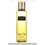 Botella cilíndrica de bruma corporal Coconut Passion con líquido amarillo, atomizador dorado y etiqueta negra que indica 250 ml.