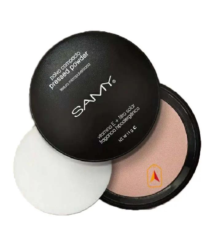 Polvo compacto Samy de 11g en tono beige, con tapa negra, estuche abierto y esponja blanca circular.