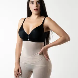 Mujer vistiendo panty moldeador beige de talle alto y sujetador negro, mostrando control de abdomen y realce de glúteos.