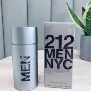 Perfume 212 Men NYC de Carolina Herrera con frasco cilíndrico plateado y caja de 60 ml sobre superficie de madera.