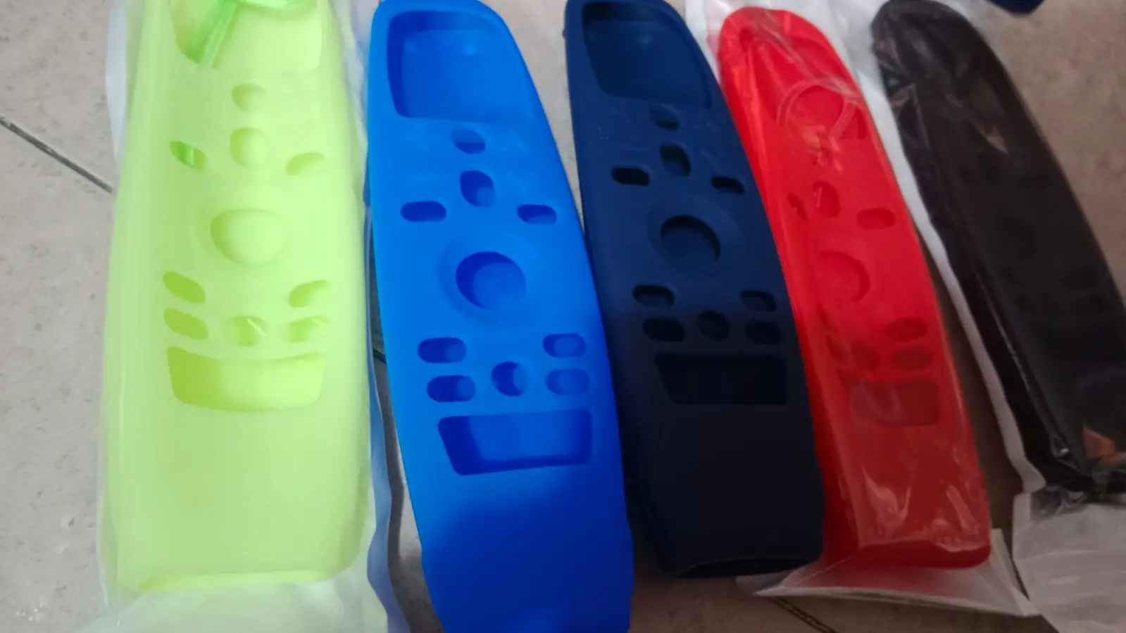 Fundas de silicona coloridas para control remoto LG Magic en tonos verde, azul, rojo y negro.