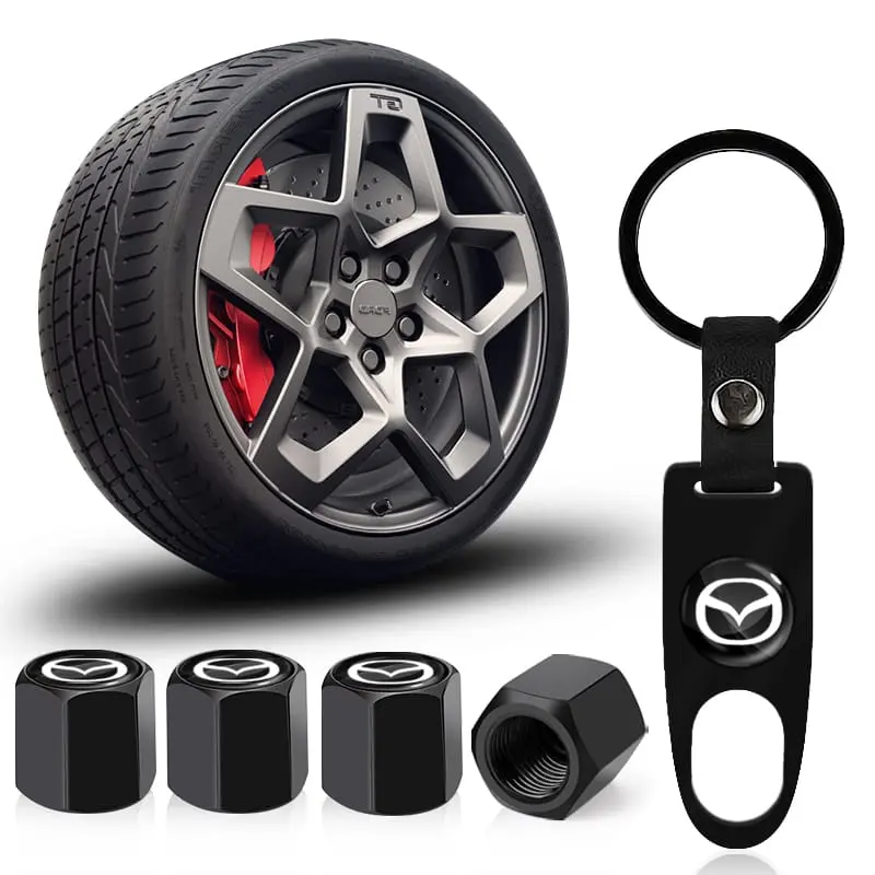 Kit negro para carro con llavero con logo, cuatro tapapolvos hexagonales de aluminio para llantas y una tuerca con rosca interna visible.