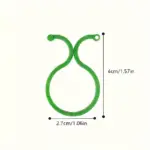 Clip de soporte verde para plantas con diseño circular ajustable, mide 4 cm de alto por 2.7 cm de ancho, ideal para guiar enredaderas y cultivos.