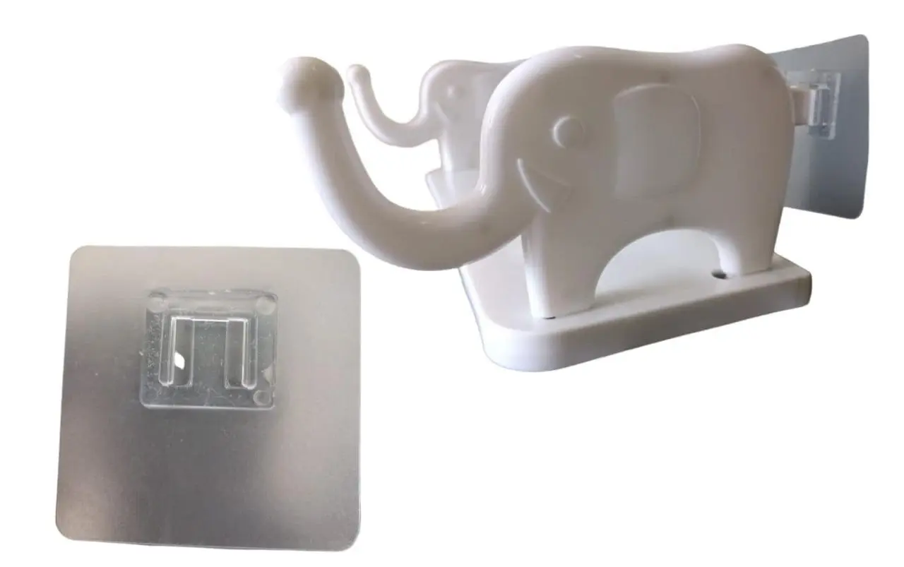 Soporte adhesivo blanco de pared con diseño de elefante, incluye base plana y gancho calado, junto con lámina adhesiva transparente.