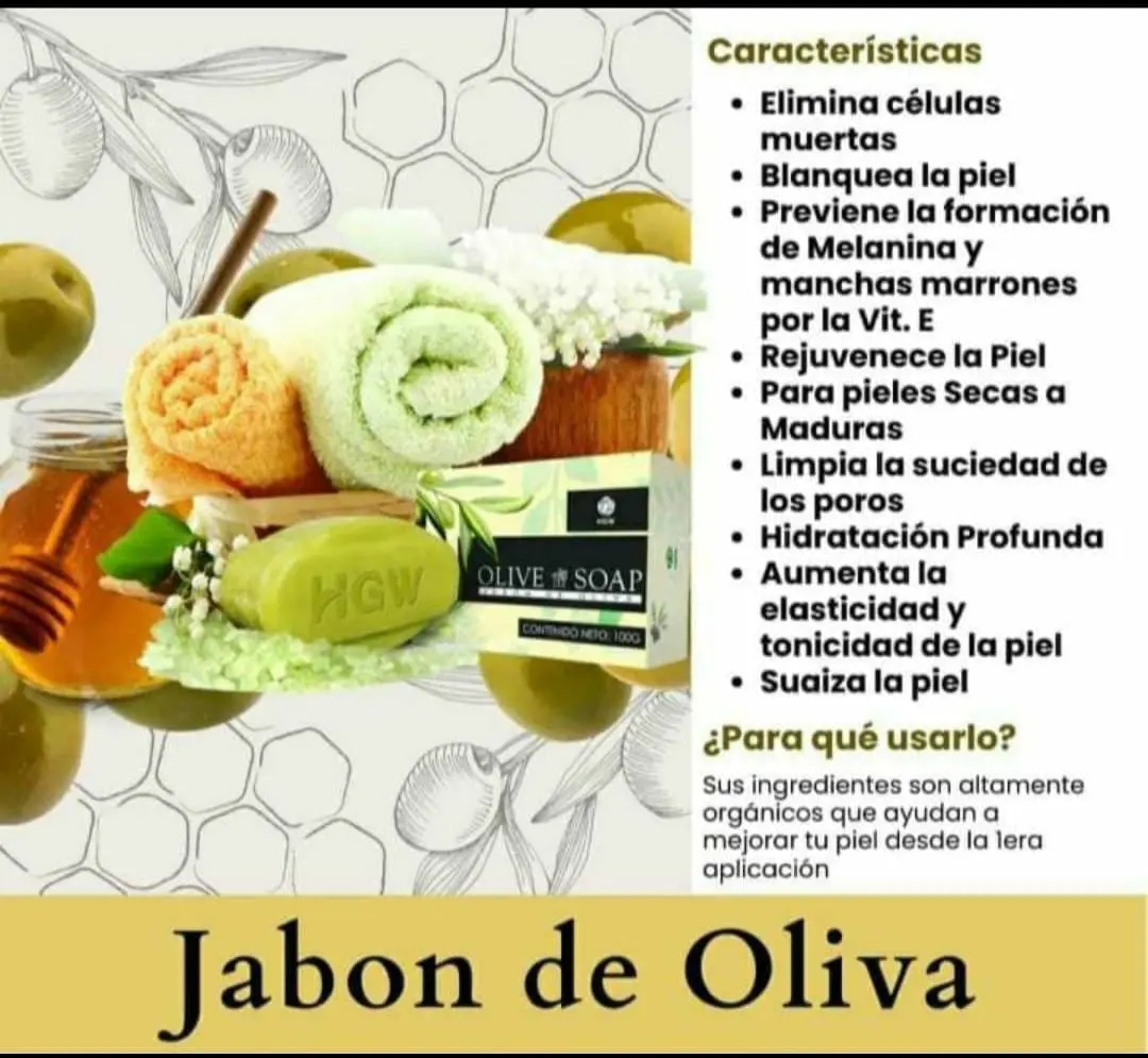 Jabón natural de oliva verde en barra de 100g junto a toallas de baño, miel y aceitunas sobre fondo claro.
