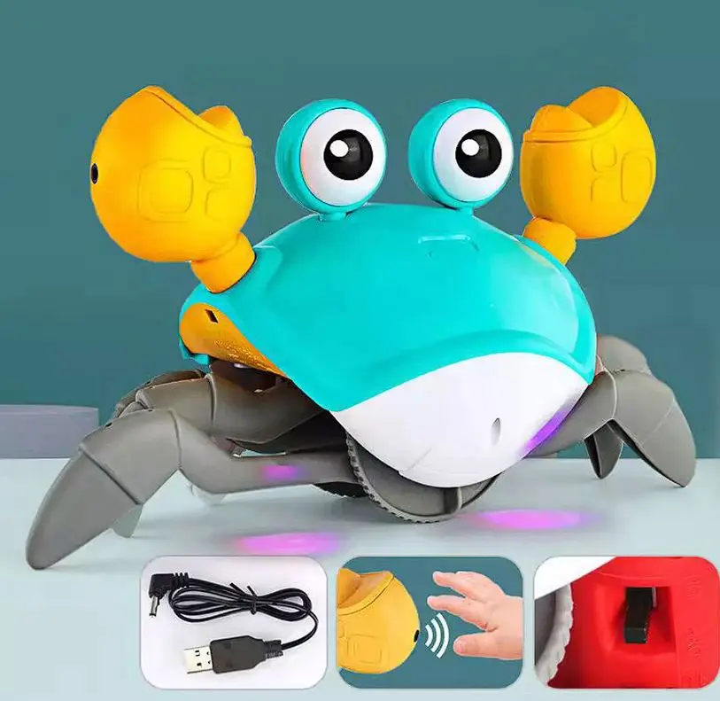 Cangrejo didáctico interactivo turquesa y amarillo con pinzas grandes, ojos móviles, patas grises y sensor de movimiento inferior, incluye cable USB de carga.