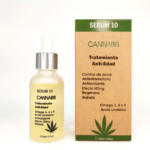 Frasco de gotero de vidrio esmerilado con líquido amarillo junto a su caja de cartón marrón y verde con hoja de cannabis y texto sérum facial anti edad