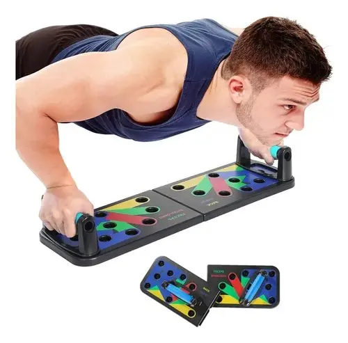 Hombre haciendo flexiones con tabla plegable negra y empuñaduras azules organizadas por zonas de colores para diferentes músculos.