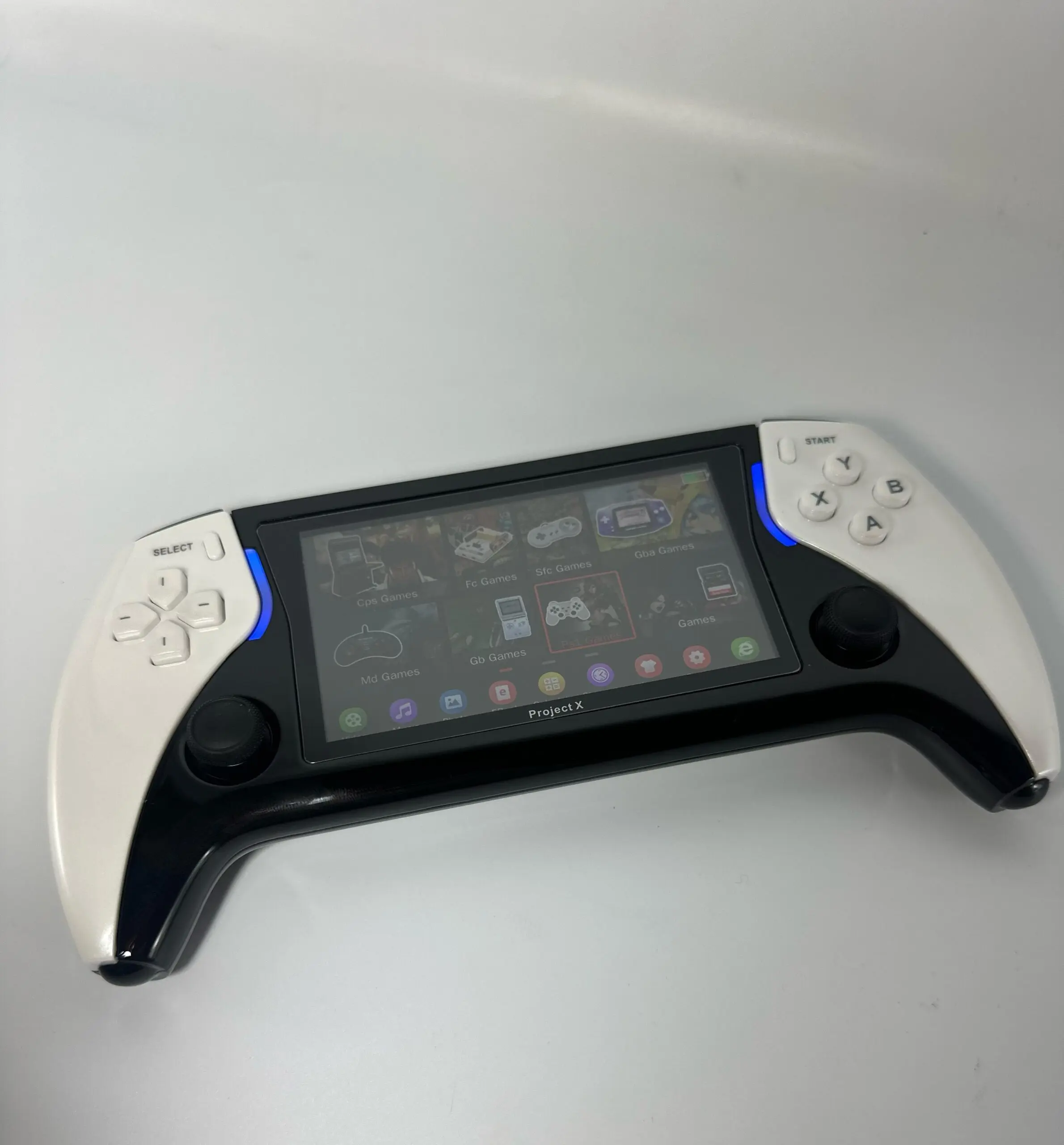 Consola portátil Play X con diseño ergonómico en negro y blanco, pantalla HD con menú de juegos y luces LED azules en los laterales.