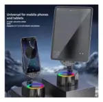 Soporte plegable negro para móviles y tablets de 3.5 a 12.9 pulgadas con base circular de luz RGB y altavoz integrado sobre superficie elevada.