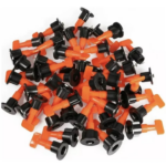 Set de 50 niveladores de cerámica con pernos en T naranja y tapas circulares negras, dispuestos en grupo para instalación de pisos nivelados.