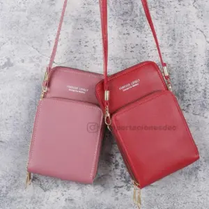 Set de dos bolsos porta celular cruzados con compartimentos, uno color rosa viejo y otro rojo, con correas delgadas y herrajes dorados.