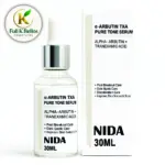 Suero facial Nida de 30 ml con Alpha Arbutin y ácido tranexámico en frasco de vidrio transparente con gotero junto a su caja blanca.
