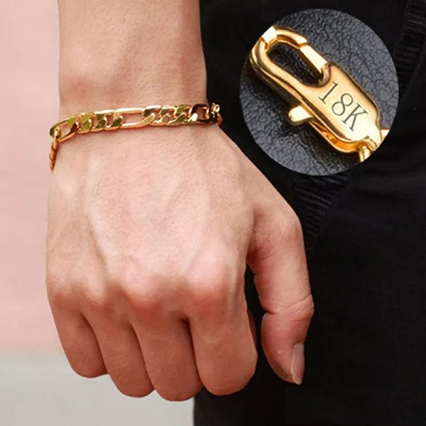 Brazalete Bismark de oro 18K con eslabones entrelazados en la muñeca, resaltando un cierre tipo mosquetón con el grabado 18K.