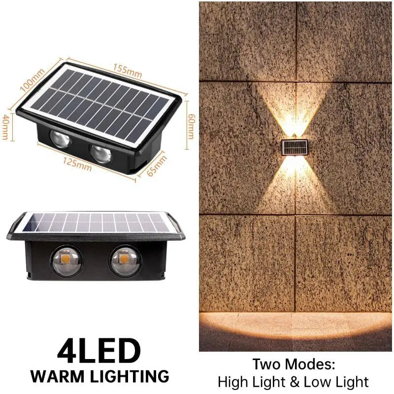 Aplique solar LED negra de 155x100mm con dos focos de luz cálida arriba y abajo, instalada en pared exterior de piedra.
